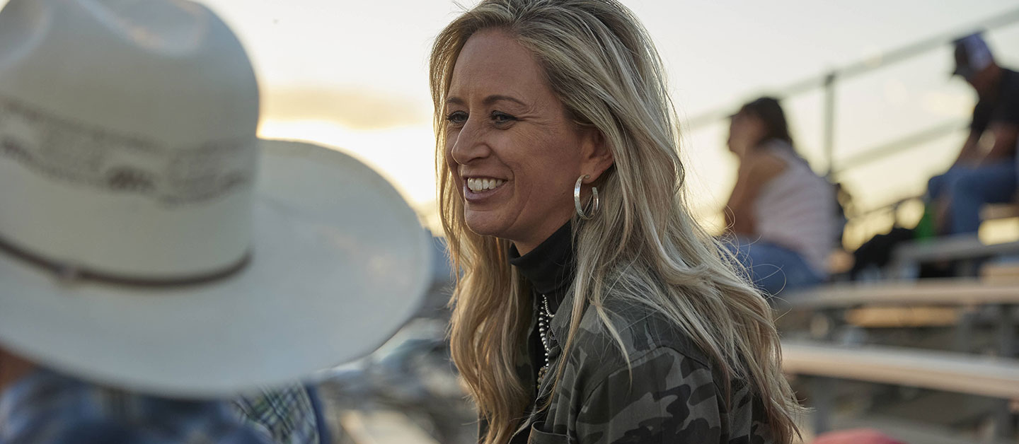 Shali talking to a friend off camera laughing and smiling.